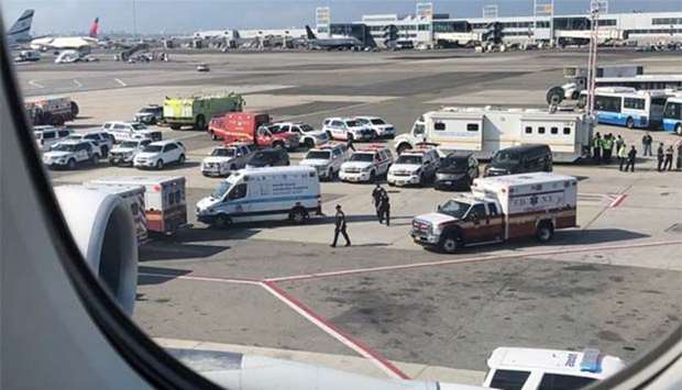 Emergency services are seen at JFK Airport, New York, after passengers were taken ill on a flight from Dubai to New York on Wednesday.