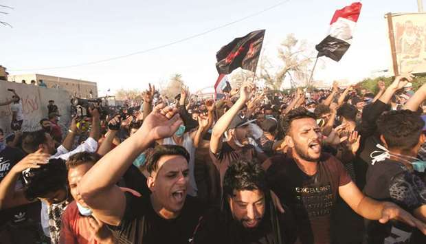 Iraqis protest near government building in Basra yesterday.