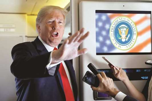 Trump speaks to reporters aboard Air Force One, on his way to Fargo, North Dakota.