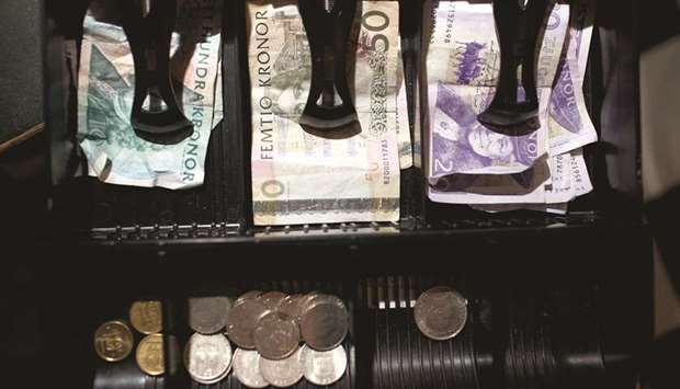 Mixed denomination krona notes and coins sit in a cashieru2019s till inside a currency exchange in Malmo, Sweden. The krona is the worst-performing Group-of-10 currency this year, having weakened more than 7% against the euro.