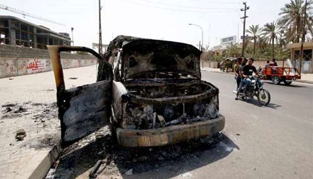 A burnt ambulance belonging to Iraq's Popular Mobilisation Forces is seen in a Basra street on Saturday.