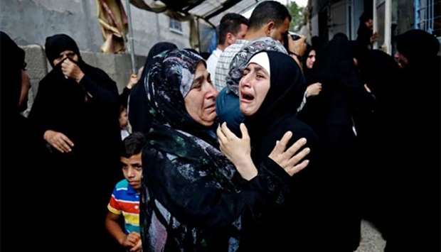 A relative mourns over the death of 17-year-old Palestinian boy Belal Khafaja, killed by Israeli forces during a protest at the Israel-Gaza border, at his funeral in Rafah on Saturday.