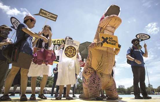 Protesters displaying placards march to the Department of Environment and Natural Resources (DENR) in Manila, yesterday, during a demonstration to denounce coal and fossil fuel industries and to call for a transformation of dirty energy to renewable energy systems.