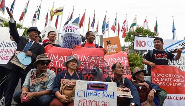 Environmental activists and supporters take part in a demonstration in front of the United Nations building in Bangkok on Saturday.