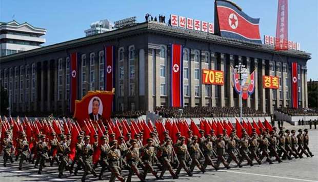 Soldiers march with the portrait of North Korean founder Kim Il Sung during a military parade marking the 70th anniversary of country's foundation in Pyongyang on Sunday.