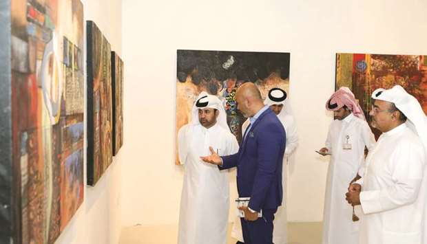 Artist Ali Ghaddaf briefs Katara u2013 the Cultural Village general manager Dr Khalid bin Ibrahim al-Sulaiti on his works.