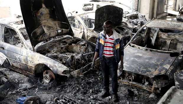 Nigerian entrepreneur Basil Onibo, one of the victims of the latest spate of xenophobic attacks looks at the burnt out cars at his dealership in Johannesburg, South Africa on September 5