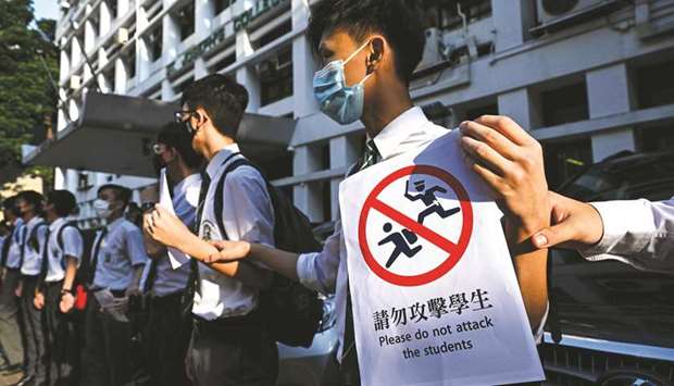 Secondary school students form a human chain against extradition bill in Hong Kong.