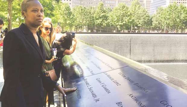 Manhattan resident Jaquelin Febrillet looks at the 9/11 Memorial on the old World Trade Center site.