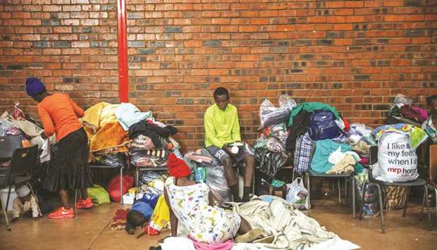 A woman holds a food plate at the Tsolo Community Hall in Johannesburgu2019s Katlehong township, where around 250 people, mostly Zimbabwean and Malawian nationals, have taken refuge after a new wave of anti-foreigner violence that hit South Africau2019s financial capital.