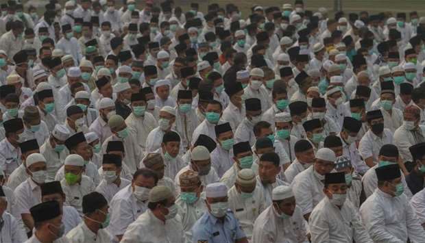 Indonesian Muslims gather as they pray for rain during a long drought season and haze in Pekanbaru