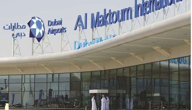 Local employees stand outside the Al-Maktoum International airport, the emirateu2019s second airport in Dubai (file). Work on the airport, designed to be one of the worldu2019s biggest with an annual capacity of more than 250mn passengers, is on hold as the Gulf economy falters, people familiar with the matter said.