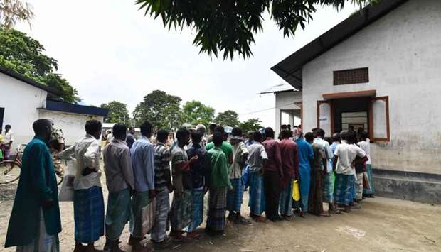 People stand in a queue to check their names on the final list of the National Register of Citizens (NRC) in an office in Pavakati village of Morigoan district, some 70 kms from Guwahati, the capital city of India's northeastern state of Assam