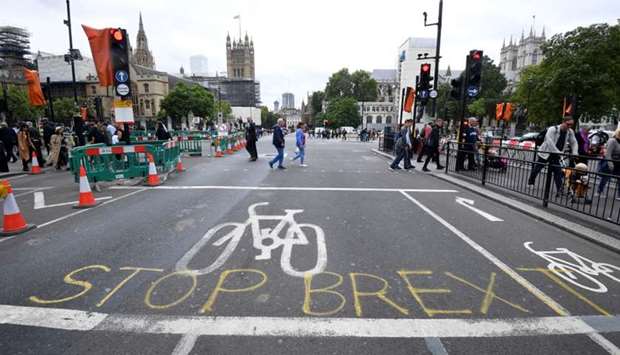 A writing on the roadside that reads ,Stop Brexit, is seen near the Houses of Parliament in London, Britain