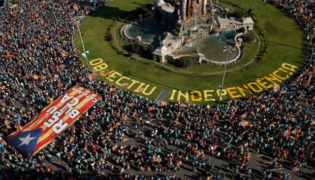 People wave Catalan pro-independence ,Estelada, flags during a demonstration marking the ,Diada,, national day of Catalonia, in Barcelona