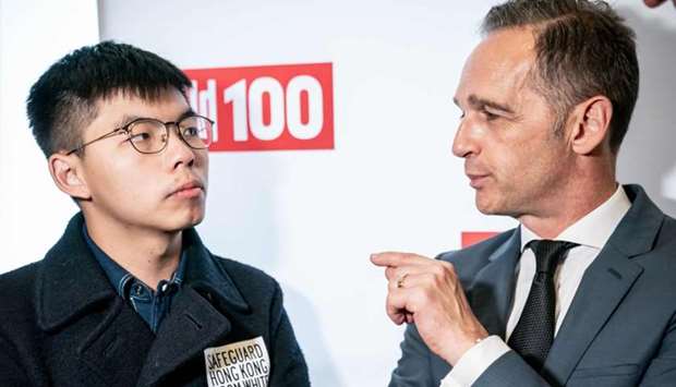 Hong Kong pro-democracy activist Joshua Wong (L) talks with German Foreign Minister Heiko Maas as they attend the ,Bild100, event organised by Germany's tabloid Bild on Monday in Berlin