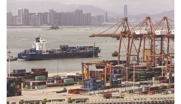A ship passes in front of containers and gantry cranes at Haitian Terminal, operated by the Xiamen Port Authority. China yesterday said it would spare some US products from punitive new tariffs, an apparent olive branch ahead of high-level talks next month to resolve the two nationsu2019 protracted trade war.