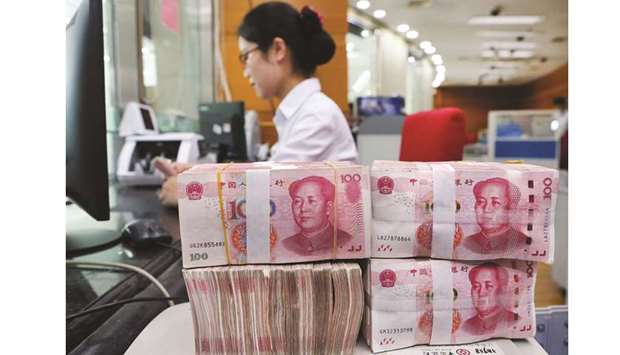 An employee counts 100-yuan notes at a bank in Nantong, Jiangsu province. Chinau2019s banks extended 1.21tn yuan ($170bn) in new loans in August, up from July and exceeding analyst expectations, Peopleu2019s Bank of China data showed yesterday.