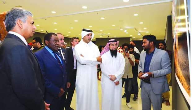 Artists brief Saif Saeed al-Dosari and other attendees about their works