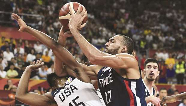 Kemba Walker (left) of the US fights for the ball with Franceu2019s Rudy Gobert during the Basketball World Cup quarter-final in Dongguan yesterday. (AFP)