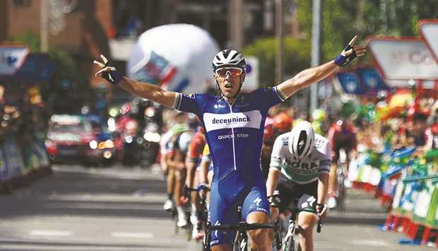 Team Deceuninck rider Belgiumu2019s Philippe Gilbert (centre) celebrates as he crosses the finish line and wins the 17th stage of the 2019 La Vuelta yesterday. (AFP)
