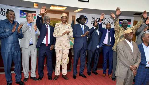 Sudanese officials, rebels and diplomats react after signing the initial agreement on a roadmap for peace talks in Juba, South Sudan