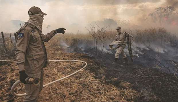 Handout picture released by the Communication Department of the State of Mato Grosso showing firefighters combating a fire in the Amazon basin in the municipality Sorriso, Mato Grosso State, Brazil, on August 26.