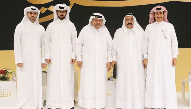 HE Sheikh Faisal bin Qassim al-Thani flanked by dignitaries.