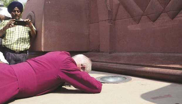 Archbishop of Canterbury, Justin Portal Welby, prostrates at the site of the Jallianwala Bagh massacre in Amritsar.