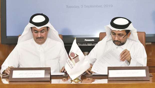 Dr Hassan al-Derham and Abdullah bin Nasser Turki al-Subaey signing the agreement.
