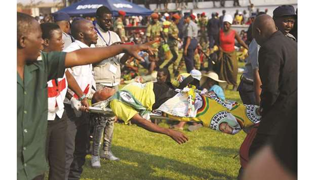 A mourner is put on a stretcher after being involved in a stampede at the Rufaro stadium in Harare yesterday.