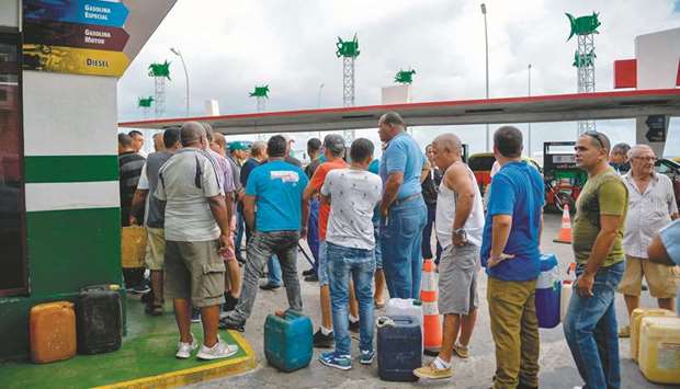 Cubans queue to buy fuel at a gas station in Havana yesterday.