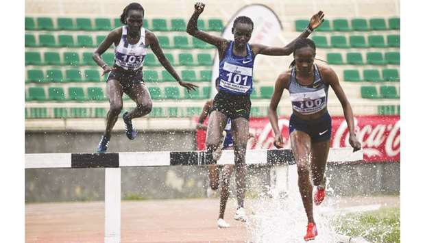 Beatrice Chepkoech (R) heads to the finish line past Hyvin Kiyeng during the women 3000m steeplechase final at the Kenyan World Championships Trials in Nairobi yesterday.