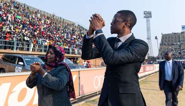 Robert Mugabe Jnr, son of late former Zimbabwean president Robert Mugabe, salutes the crowd gathered for viewing the body of Robert Mugabe who was lying in state during a public send off at the Rufaro Stadium in Harare