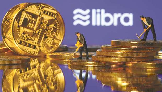 Small toy figures are seen on representations of virtual currency in front of the Libra logo in an illustration picture. Eurozone governments and central banks are working on a long-term plan to launch a public digital currency that they hope would make redundant projects like Facebooku2019s Libra, which is seen as a risk to financial stability, officials said yesterday.