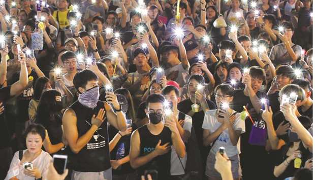 People hold up mobile phones during the mid-autumn festival, in Sha Tin, Hong Kong.