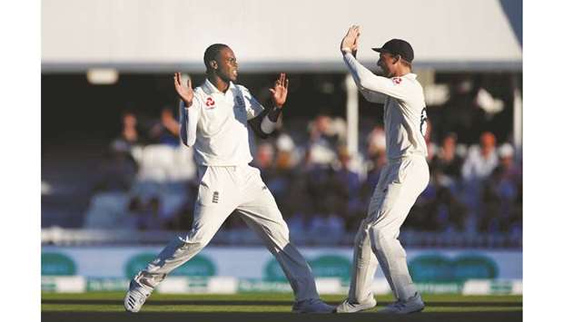 Englandu2019s Jofra Archer celebrates with Jos Buttler after taking the wicket of Australiau2019s Nathan Lyon at The Oval in London yesterday.