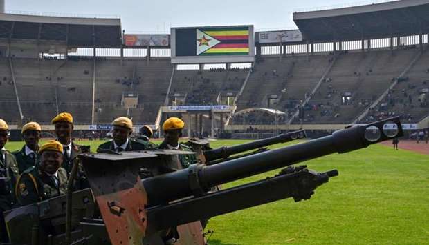 Zimbabwe soldiers prepare ceremonial canons to be used in rendering a gun salute, at the National Sports stadium where the official funeral for Robert Mugabe is to be held in Harare