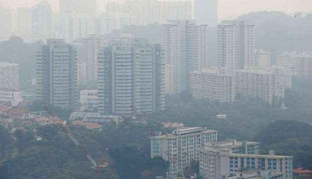 Public housing apartment blocks are shrouded by haze yesterday in Singapore