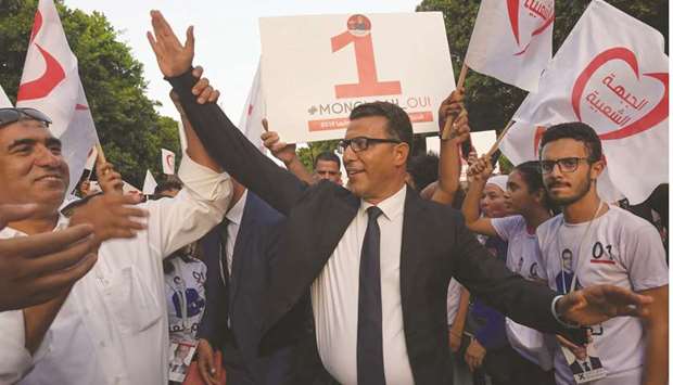 Tunisiau2019s presidential candidate Mongi Rahoui greets his supporters during a campaign event in Tunis, yesterday.