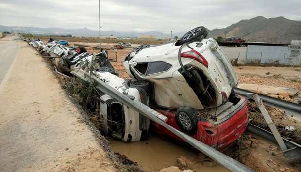 New cars are seen piled after a flood caused by torrential rains in Orihuela, Spain
