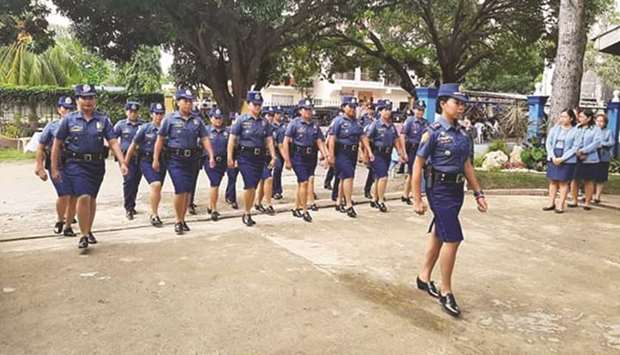 Officers and members of Maria Municipal Police Station march during the launch of the all-women police station in Siquijor.
