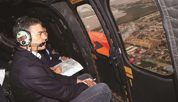 A picture released by the press office of the Spanish premier shows Sanchez in the helicopter flying over flooded areas near Orihuela.