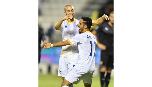 Al Gharafau2019s Othman al-Yahri is congratulated by a teammate after he scored against Qatar Sports Club yesterday.