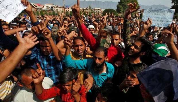 Kashmiris shout slogans at a protest site after Friday prayers during restrictions in Srinagar.
