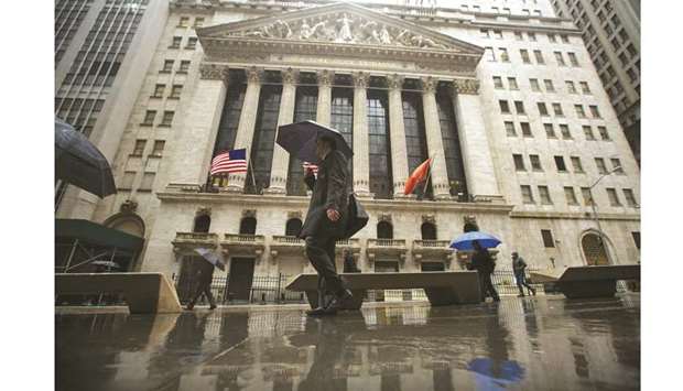 Pedestrians walk past the New York Stock Exchange. With US-China trade tensions roiling markets, investors are counting on support for stocks coming from a Federal Reserve willing to keep cutting interest rates to help the US economy avoid a severe downturn.