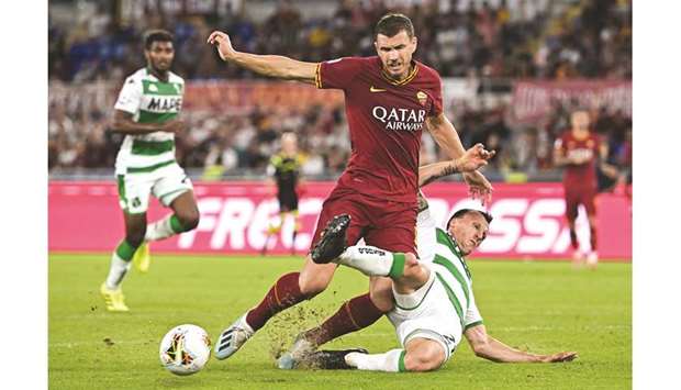 Sassuolou2019s Vlad Chiriches (right) tackles Romau2019s Edin Dzeko during the Italian Serie A match in Rome yesterday. (AFP)