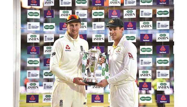 Englandu2019s captain Joe Root (left) and Australiau2019s captain Tim Paine hold the Ashes trophy during the  presentation ceremony on the fourth day of the 5th Ashes Test at The Oval in London yesterday. (AFP)