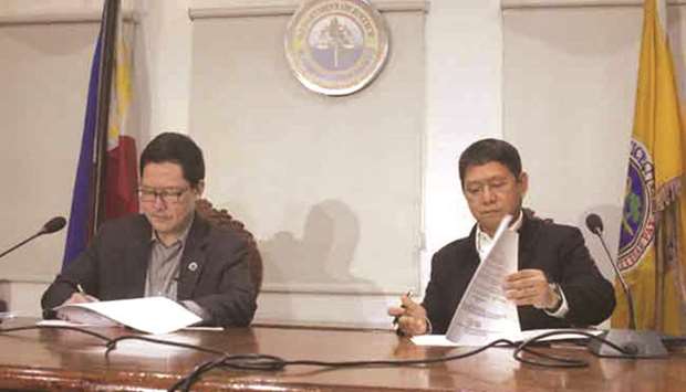 Justice Secretary Menardo Guevarra (left) and Interior Secretary Eduardo Ano sign the revised implementing rules and regulations for the Republic Act 10592.