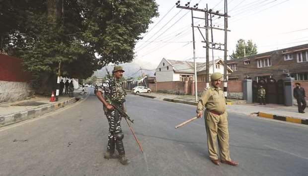 Policemen stand guard outside the residence of former chief minister of the Jammu and Kashmir, Farooq Abdullah, in Srinagar yesterday.